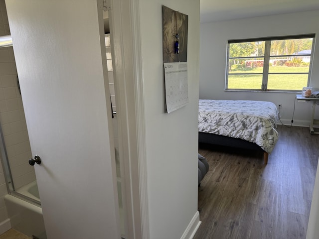 bedroom featuring dark wood finished floors and baseboards