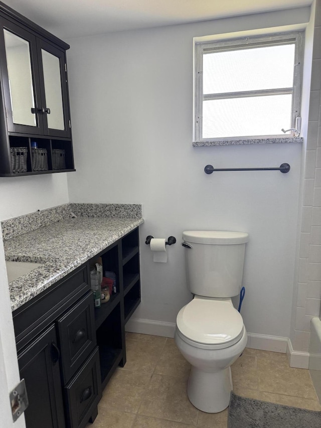 full bathroom featuring tile patterned flooring, vanity, toilet, and baseboards