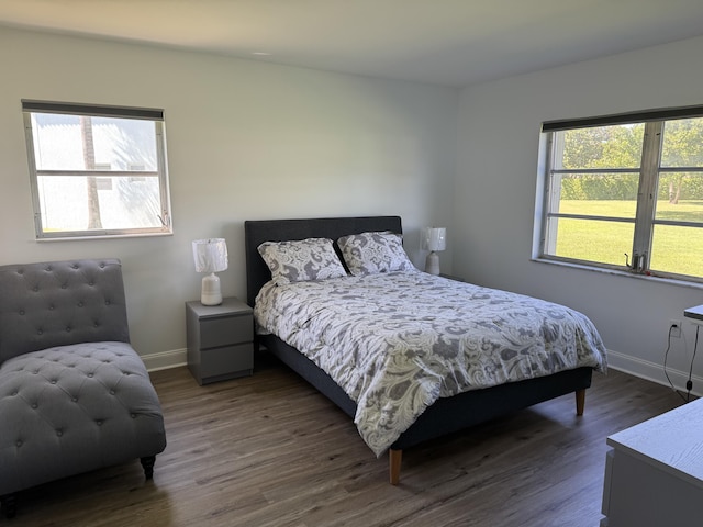 bedroom featuring dark wood-type flooring and baseboards