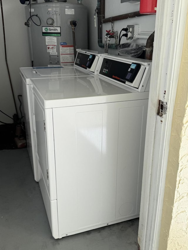 washroom featuring washing machine and dryer and gas water heater