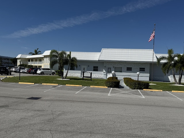 view of building exterior featuring uncovered parking