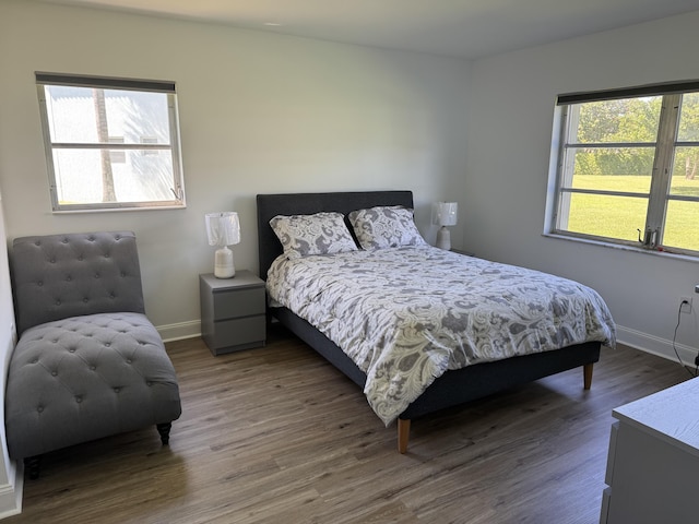 bedroom featuring wood finished floors and baseboards