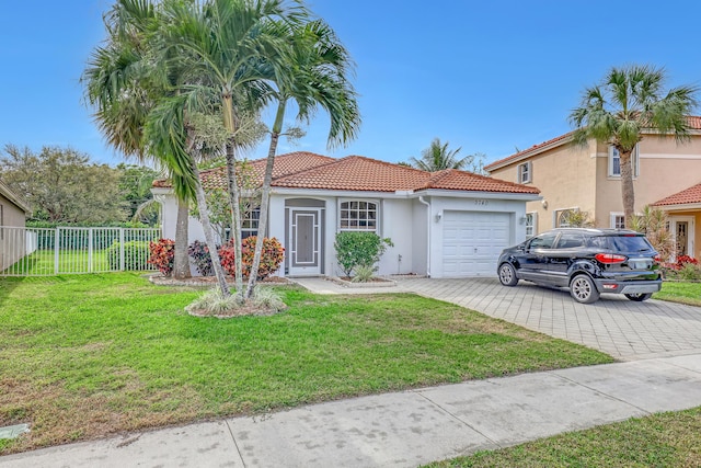 mediterranean / spanish home with a front yard and a garage