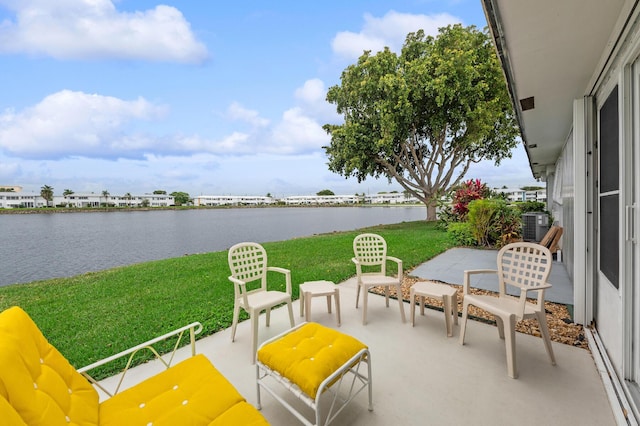 view of patio / terrace featuring cooling unit and a water view