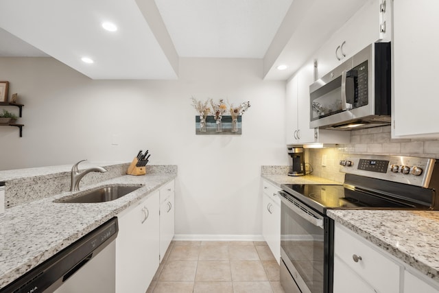 kitchen with white cabinets, stainless steel appliances, and sink