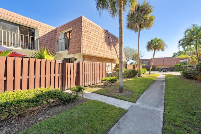 view of property exterior with a yard