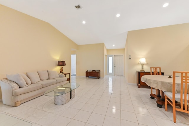 living area with visible vents, recessed lighting, light tile patterned floors, baseboards, and vaulted ceiling