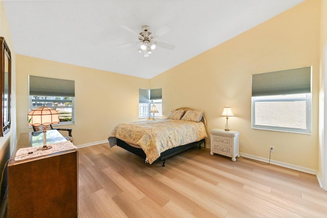 bedroom featuring light wood-style flooring, baseboards, lofted ceiling, and ceiling fan