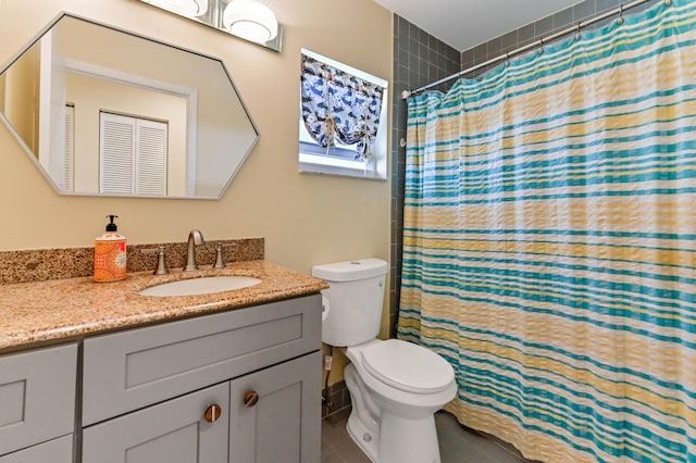 bathroom featuring tile patterned floors, a shower with curtain, toilet, and vanity