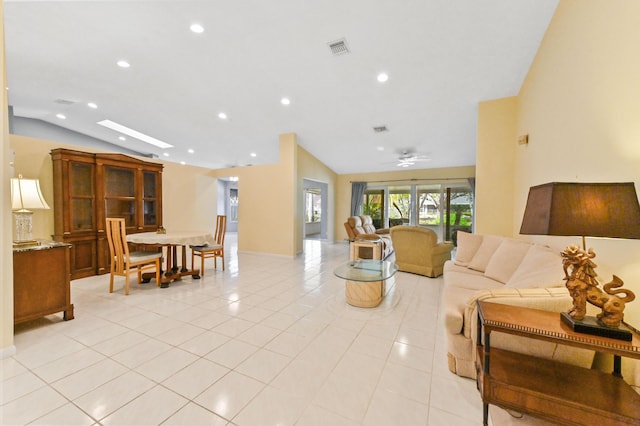 living room featuring visible vents, ceiling fan, vaulted ceiling with skylight, recessed lighting, and light tile patterned flooring