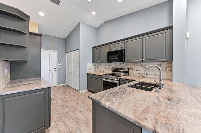 kitchen with stainless steel electric range oven, light stone countertops, gray cabinets, a sink, and black microwave