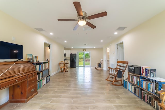 sitting room featuring ceiling fan