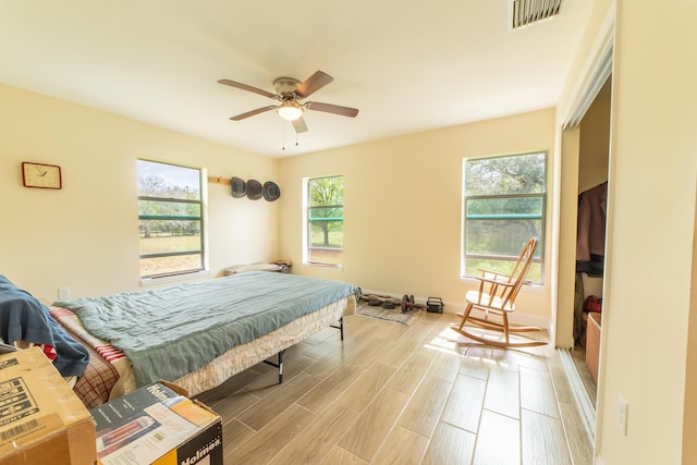 bedroom with light hardwood / wood-style floors and ceiling fan