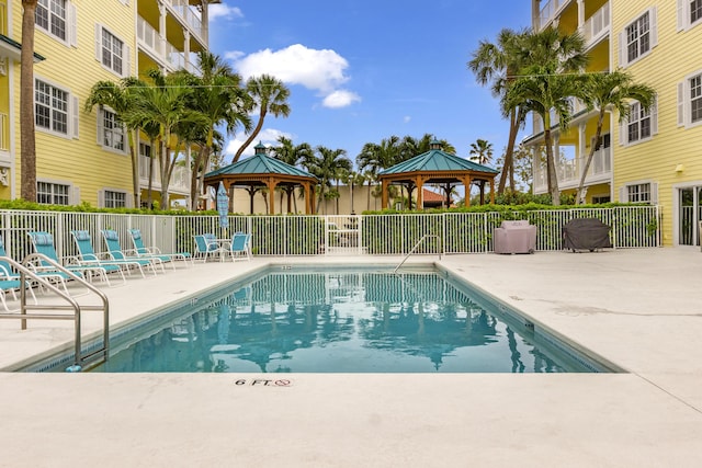 community pool featuring a gazebo, a patio, and fence