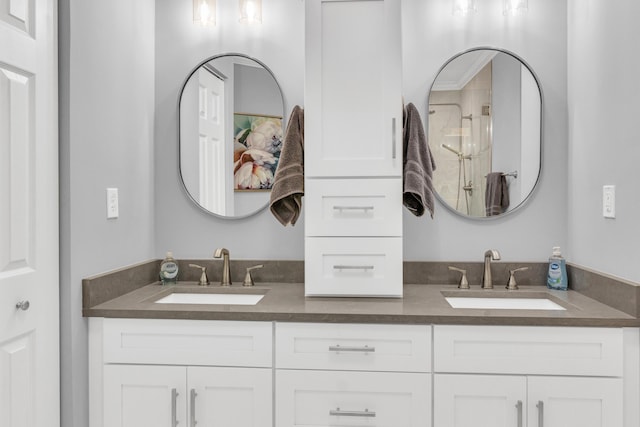 bathroom with double vanity, an enclosed shower, and a sink