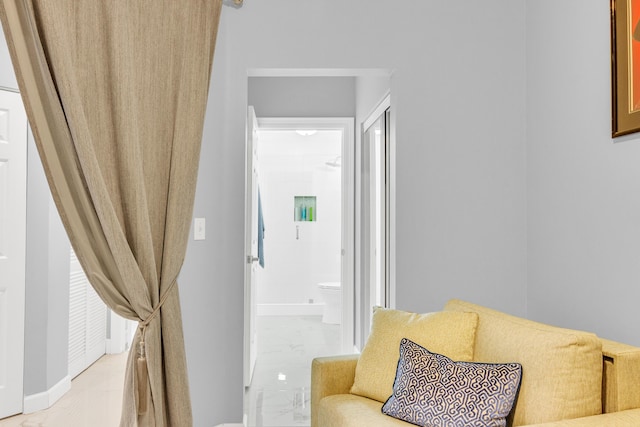 hallway featuring marble finish floor