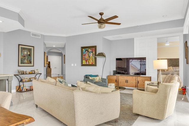 living area with arched walkways, marble finish floor, visible vents, and crown molding