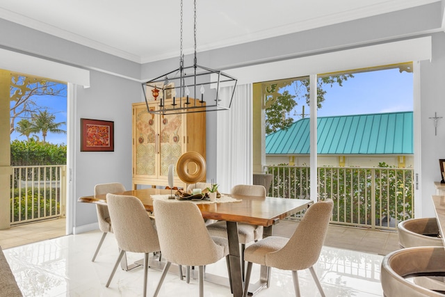 dining area with ornamental molding and an inviting chandelier