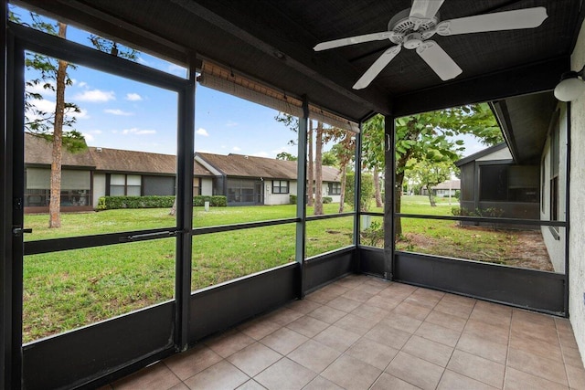 unfurnished sunroom with ceiling fan