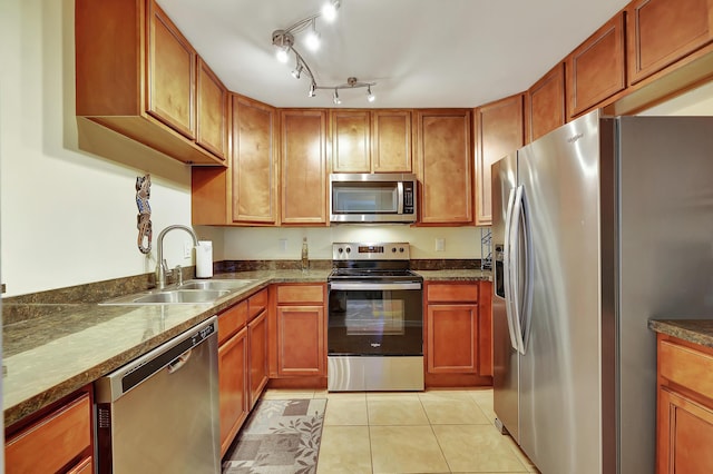 2050 Oleander Blvd Unit 1106, Fort Pierce, FL 34950 - kitchen featuring appliances with stainless steel finishes, a sink, dark countertops, and light tile patterned flooring