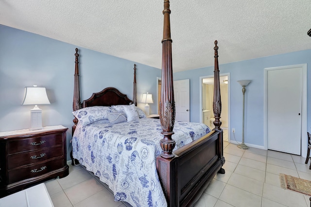2050 Oleander Blvd Unit 1106, Fort Pierce, FL 34950 - bedroom with light tile patterned floors, a textured ceiling, and connected bathroom