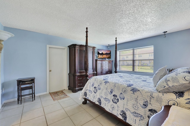 2050 Oleander Blvd Unit 1106, Fort Pierce, FL 34950 - bedroom featuring light tile patterned floors, a textured ceiling, and baseboards