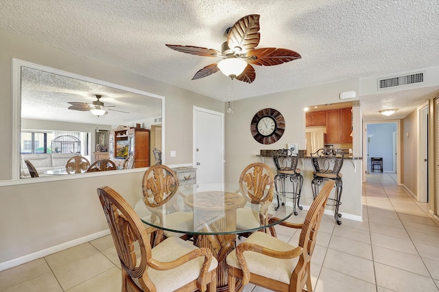 2050 Oleander Blvd Unit 1106, Fort Pierce, FL 34950 - dining room with ceiling fan, light tile patterned floors, a textured ceiling, and baseboards
