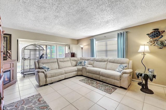 2050 Oleander Blvd Unit 1106, Fort Pierce, FL 34950 - living room featuring a textured ceiling, light tile patterned flooring, and a glass covered fireplace