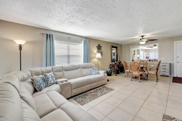 2050 Oleander Blvd Unit 1106, Fort Pierce, FL 34950 - living area featuring light tile patterned flooring, a textured ceiling, and ceiling fan
