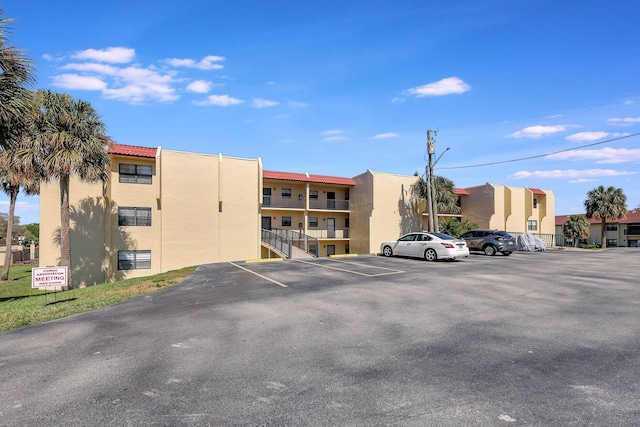 2050 Oleander Blvd Unit 1106, Fort Pierce, FL 34950 - view of building exterior with uncovered parking
