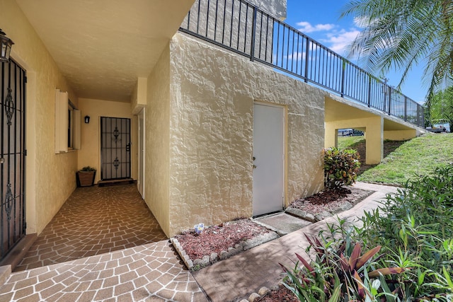 2050 Oleander Blvd Unit 1106, Fort Pierce, FL 34950 - view of exterior entry featuring stucco siding and a balcony