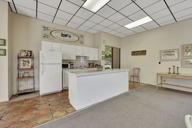 2050 Oleander Blvd Unit 1106, Fort Pierce, FL 34950 - kitchen featuring white appliances, white cabinetry, light countertops, and tasteful backsplash