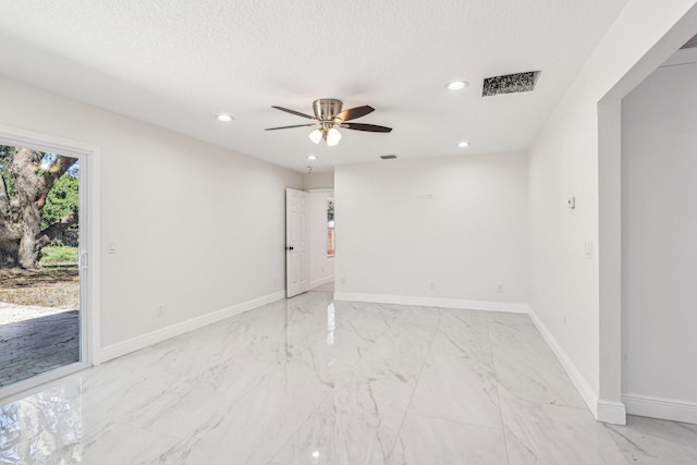 spare room featuring a textured ceiling and ceiling fan