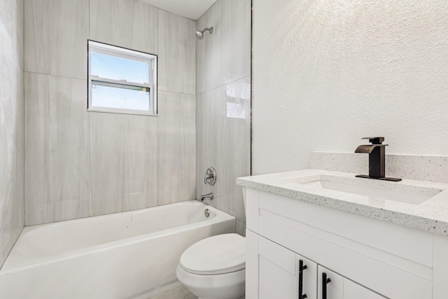 full bathroom featuring toilet, vanity, and tiled shower / bath combo