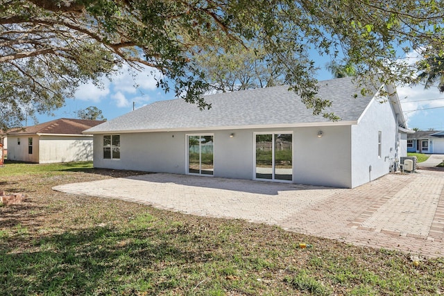 rear view of house featuring a patio and a yard