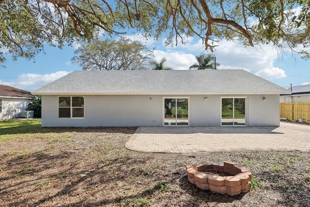 back of house with a patio and a fire pit