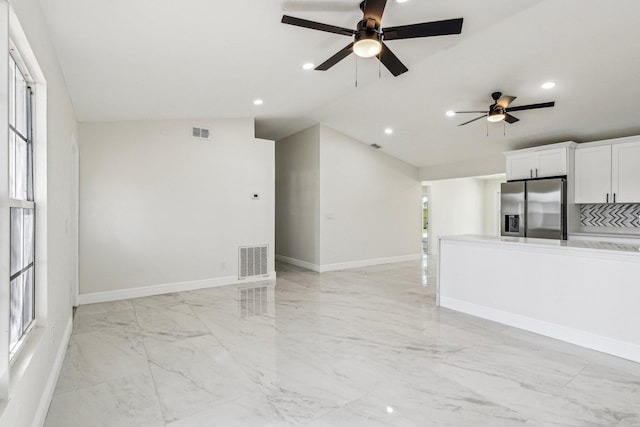 spare room featuring lofted ceiling and ceiling fan