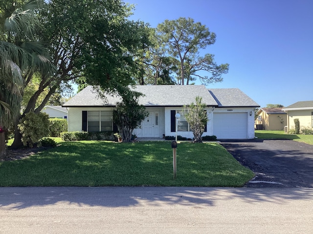 single story home with a front lawn and a garage