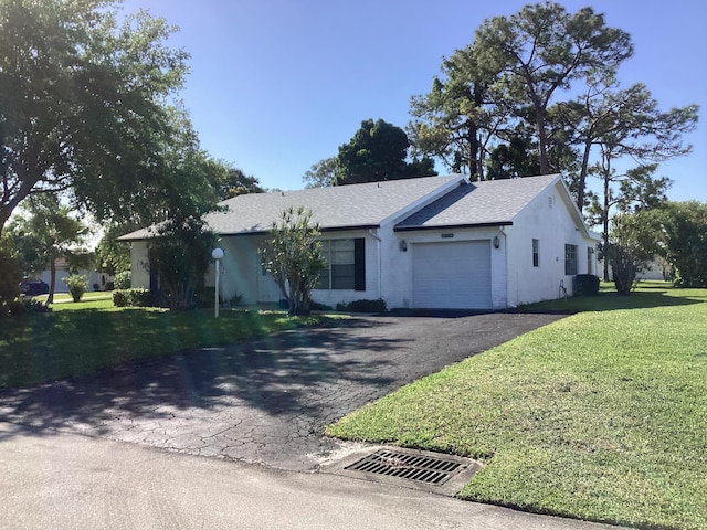 ranch-style house with a front yard and a garage