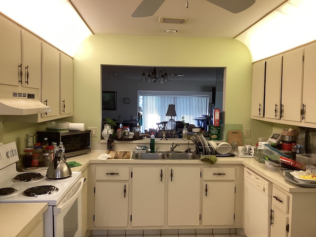 kitchen with white appliances, ceiling fan, white cabinets, and sink