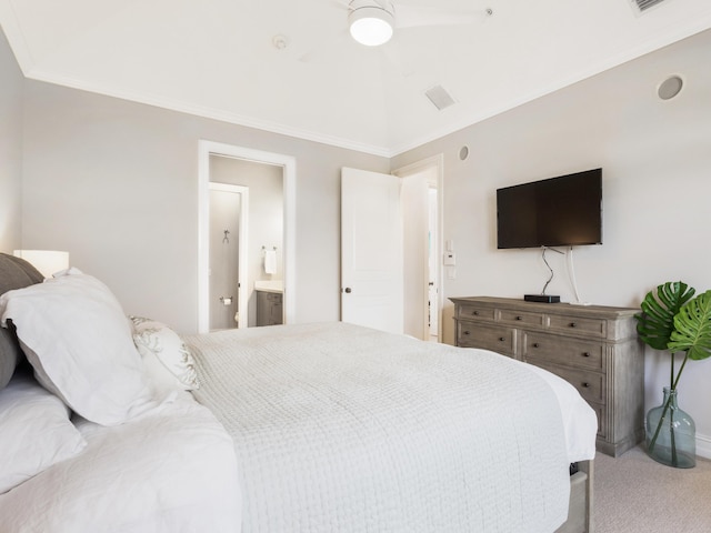 carpeted bedroom with visible vents, baseboards, crown molding, and ensuite bathroom