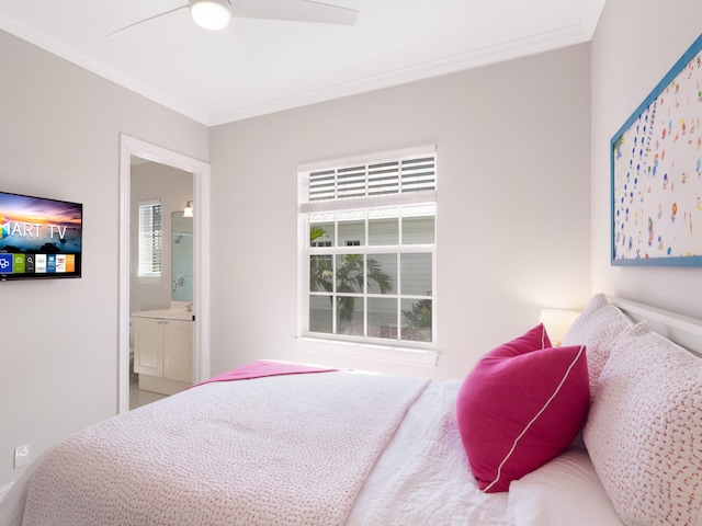 bedroom featuring ceiling fan, ensuite bath, and crown molding