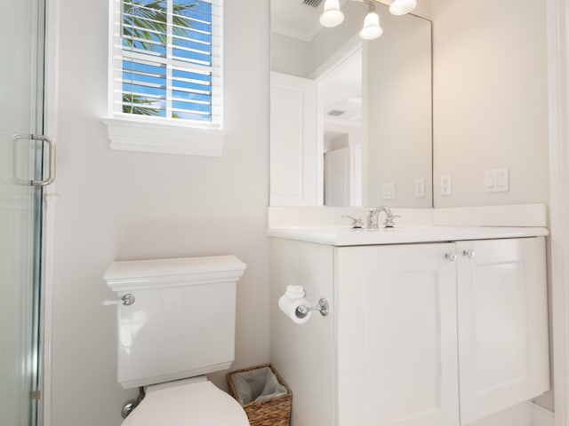 bathroom with vanity, an enclosed shower, and toilet