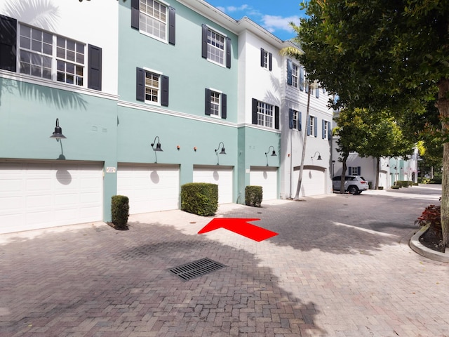 view of property with driveway and an attached garage