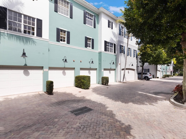 view of building exterior featuring a garage and driveway