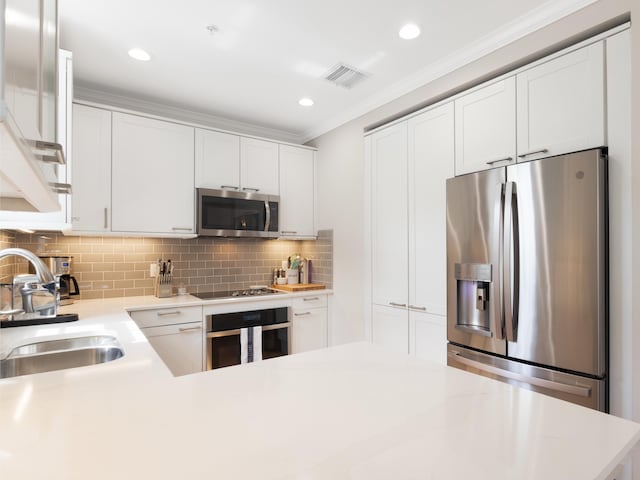 kitchen featuring white cabinetry, appliances with stainless steel finishes, and light countertops