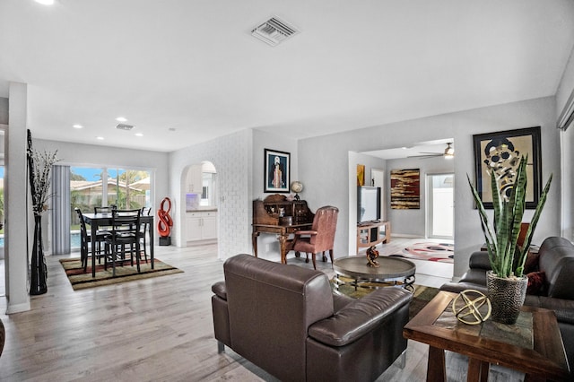 2144 NE 63rd St, Fort Lauderdale, FL 33308 - living room with light wood-type flooring, visible vents, arched walkways, and recessed lighting