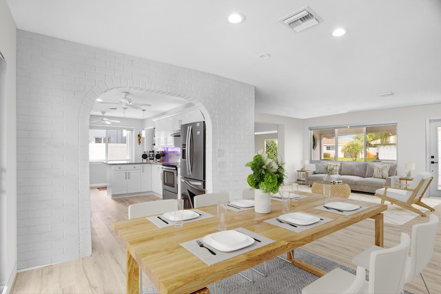 2144 NE 63rd St, Fort Lauderdale, FL 33308 - dining space featuring arched walkways, visible vents, ceiling fan, and light wood finished floors