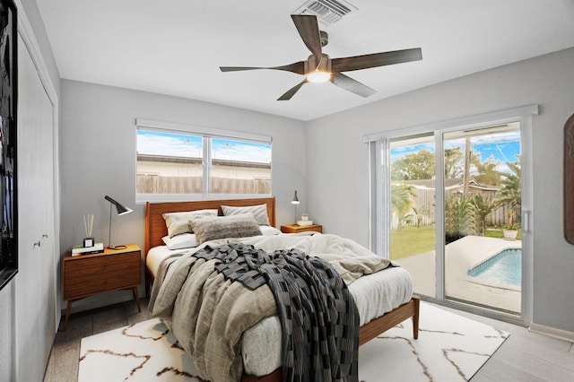 2144 NE 63rd St, Fort Lauderdale, FL 33308 - bedroom featuring light wood-type flooring, access to exterior, multiple windows, and visible vents