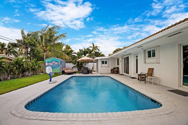 2144 NE 63rd St, Fort Lauderdale, FL 33308 - view of pool with a fenced in pool, a patio, a storage shed, a fenced backyard, and an outdoor structure